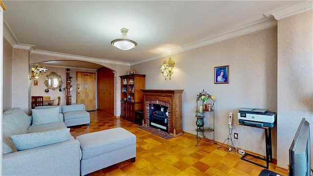 living room with parquet flooring, ornamental molding, and a fireplace