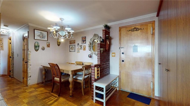 dining area with parquet floors, ornamental molding, and an inviting chandelier