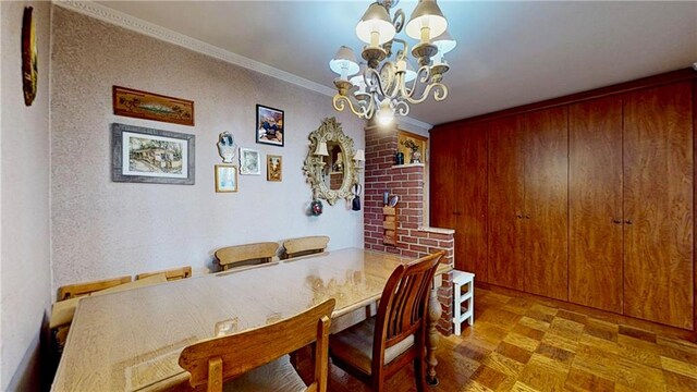 dining area featuring an inviting chandelier and crown molding