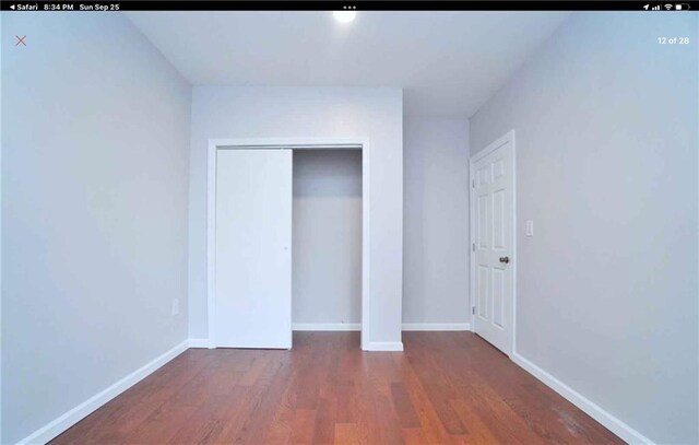 unfurnished bedroom featuring dark hardwood / wood-style floors