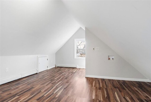 bonus room with lofted ceiling, dark hardwood / wood-style flooring, and a baseboard heating unit