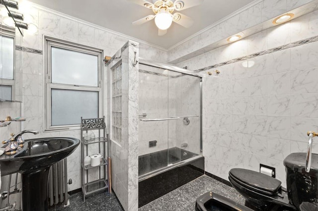 full bath with tile walls, toilet, combined bath / shower with glass door, crown molding, and a sink