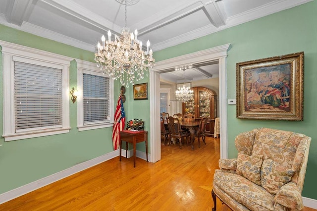 sitting room featuring crown molding, light wood-style flooring, a chandelier, coffered ceiling, and baseboards