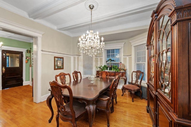 dining room featuring radiator, beamed ceiling, a chandelier, ornamental molding, and light hardwood / wood-style floors