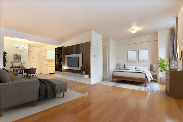 bedroom with light hardwood / wood-style floors and a notable chandelier