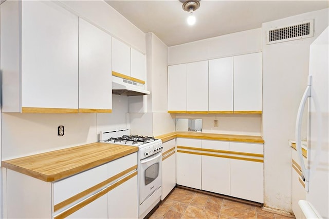 kitchen featuring refrigerator, white cabinetry, and white range with gas cooktop