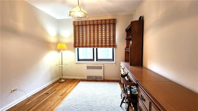 interior space with radiator and light wood-type flooring