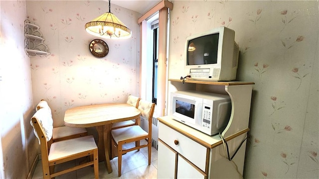 dining area featuring wallpapered walls