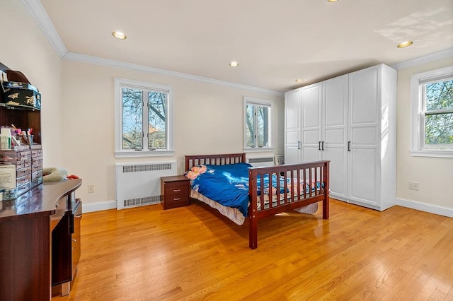 bedroom featuring radiator, ornamental molding, and light hardwood / wood-style flooring