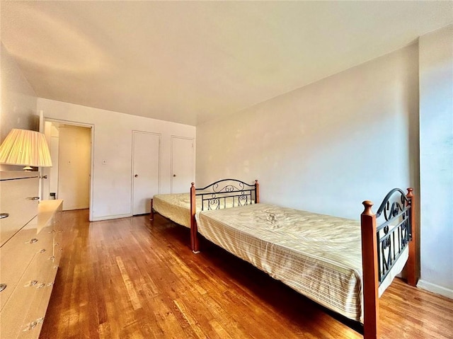 bedroom with wood-type flooring