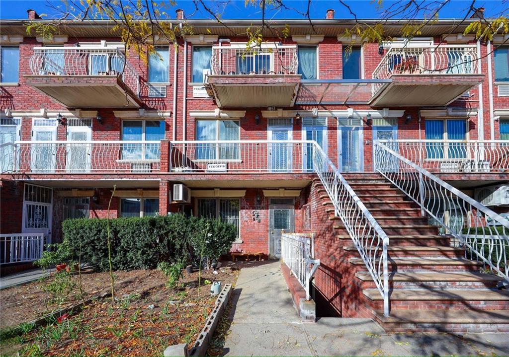 townhome / multi-family property with brick siding
