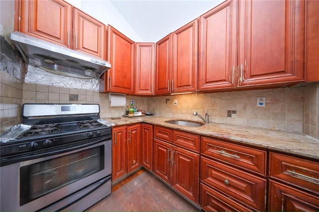 kitchen with tasteful backsplash, sink, stainless steel range with gas stovetop, light stone countertops, and ventilation hood