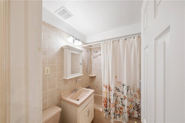 full bathroom featuring vanity, tile walls, shower / bathtub combination with curtain, and toilet