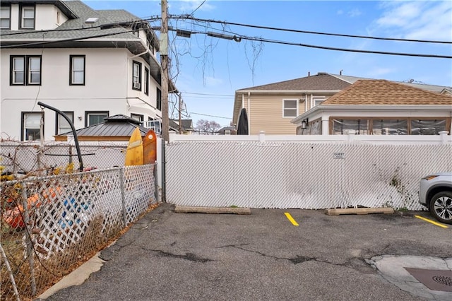 exterior space with driveway and a gate