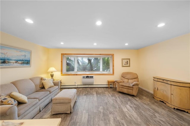 living area featuring baseboards, wood finished floors, a wall mounted air conditioner, baseboard heating, and recessed lighting