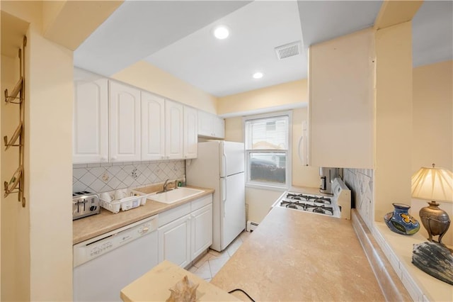 kitchen featuring light tile patterned floors, sink, white appliances, white cabinets, and decorative backsplash