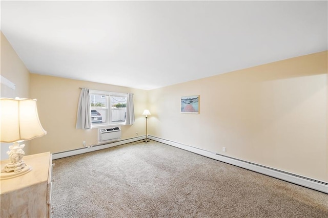 spare room with a baseboard heating unit, carpet floors, and a wall unit AC