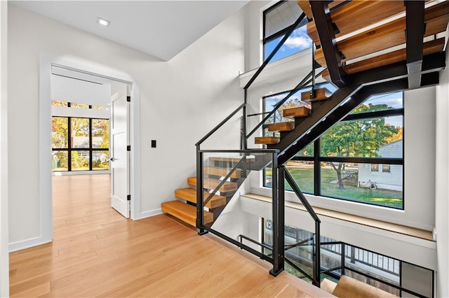 stairway with baseboards and wood finished floors