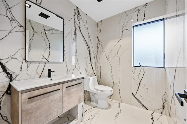 bathroom featuring toilet and stone wall