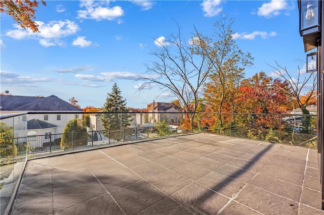 view of patio featuring a residential view and fence