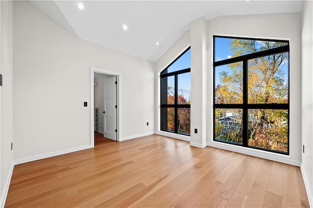 interior space with recessed lighting, baseboards, vaulted ceiling, and light wood finished floors