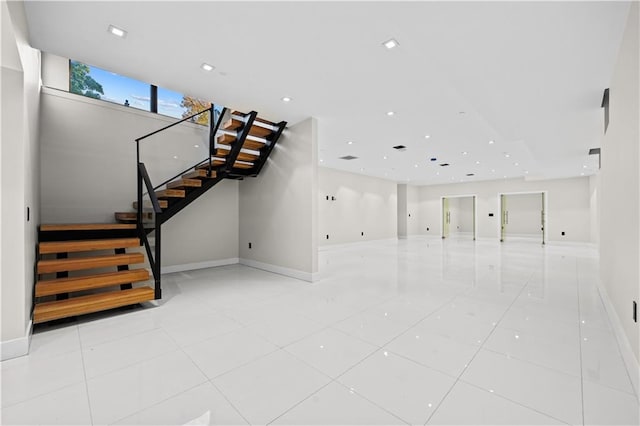 unfurnished living room with recessed lighting, light tile patterned flooring, stairway, and baseboards