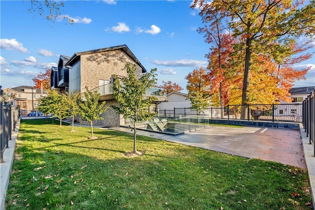 view of yard featuring fence and a patio