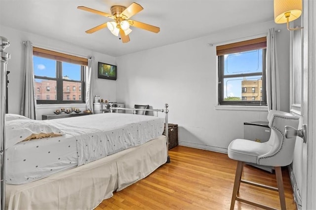 bedroom featuring light wood-style flooring and a ceiling fan