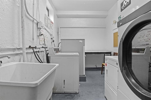 shared laundry area featuring a sink and separate washer and dryer