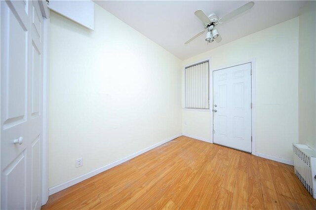 unfurnished bedroom featuring light wood-type flooring, radiator heating unit, and ceiling fan