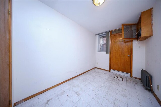 unfurnished room featuring lofted ceiling