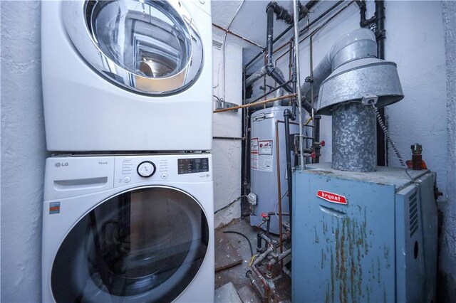 washroom with gas water heater and stacked washer / drying machine