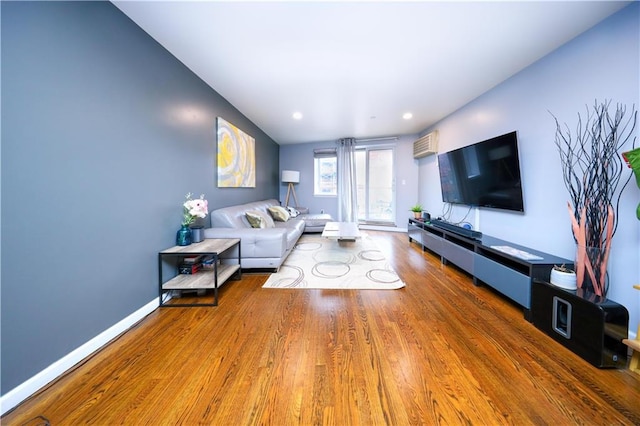 living room with recessed lighting, wood finished floors, and baseboards