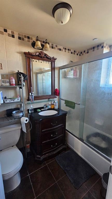 6422 Bay Pkwy Unit 6B, Brooklyn, NY 11204 - bathroom with tile patterned flooring, vanity, and shower / bath combination with glass door