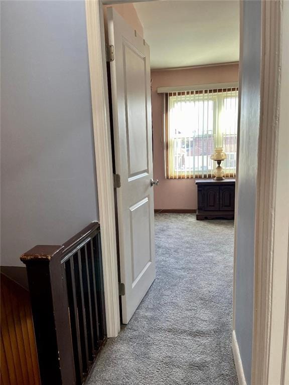 hallway with light carpet and baseboards