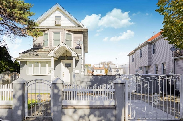 view of front of house with a fenced front yard and a gate