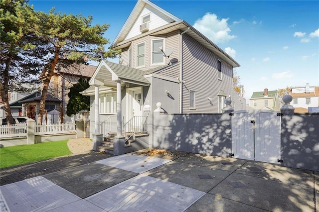 view of front facade with fence private yard, a patio area, and a gate