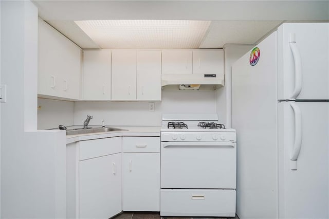 kitchen featuring sink, white cabinets, and white appliances