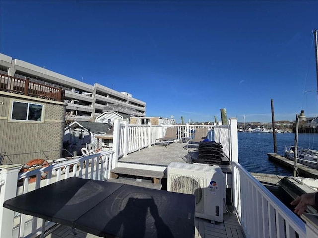 exterior space featuring a deck with water view and ac unit