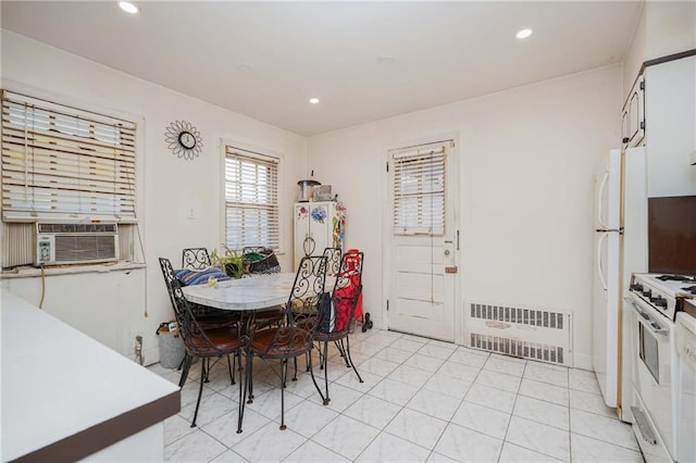 dining space with recessed lighting, cooling unit, and radiator heating unit