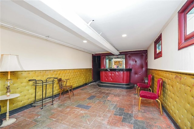 bar with stone tile floors, wainscoting, and recessed lighting