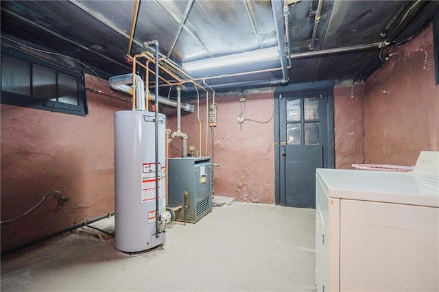 unfinished basement featuring washer / clothes dryer, water heater, and a heating unit