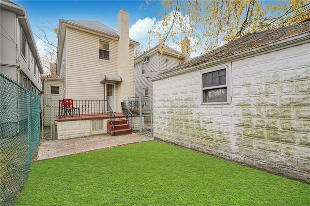 rear view of house featuring a patio area and a wooden deck