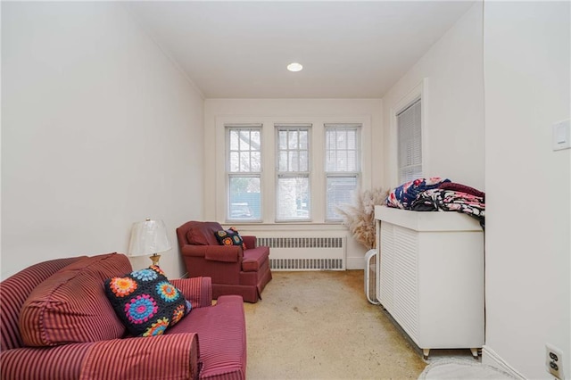 living area with radiator heating unit and baseboards