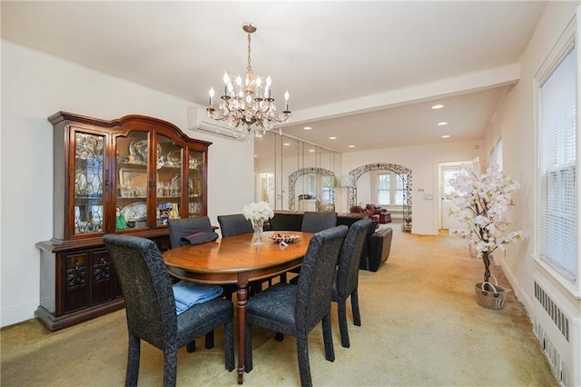 dining area with radiator heating unit, light carpet, a chandelier, baseboards, and an AC wall unit