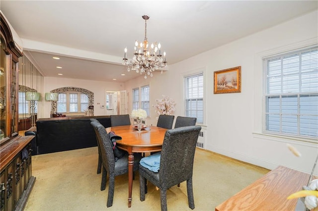 dining space featuring a chandelier, recessed lighting, light carpet, and baseboards