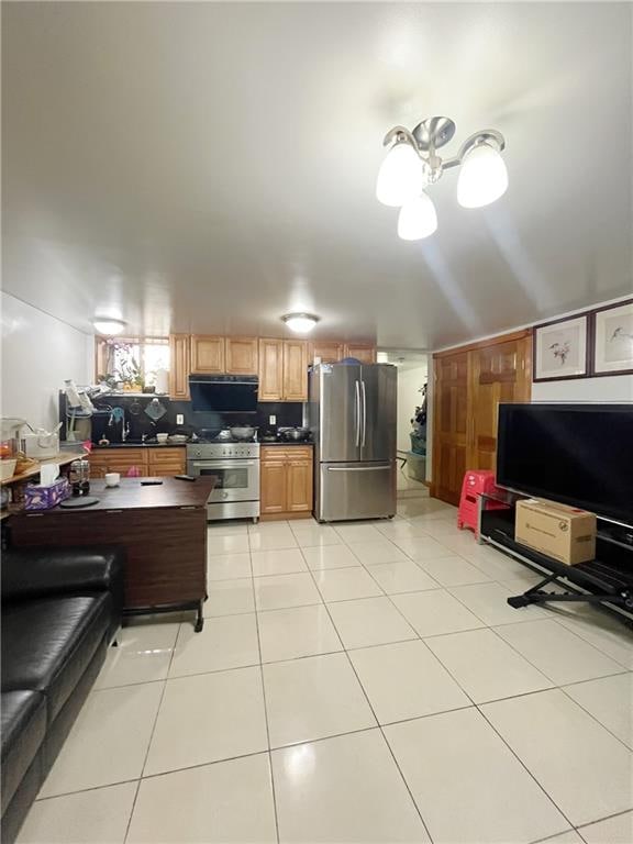 kitchen featuring appliances with stainless steel finishes, backsplash, light tile patterned floors, and range hood