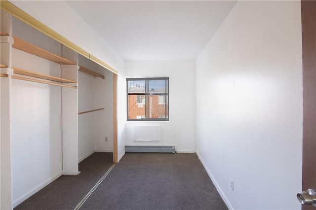 unfurnished bedroom featuring a closet and baseboard heating