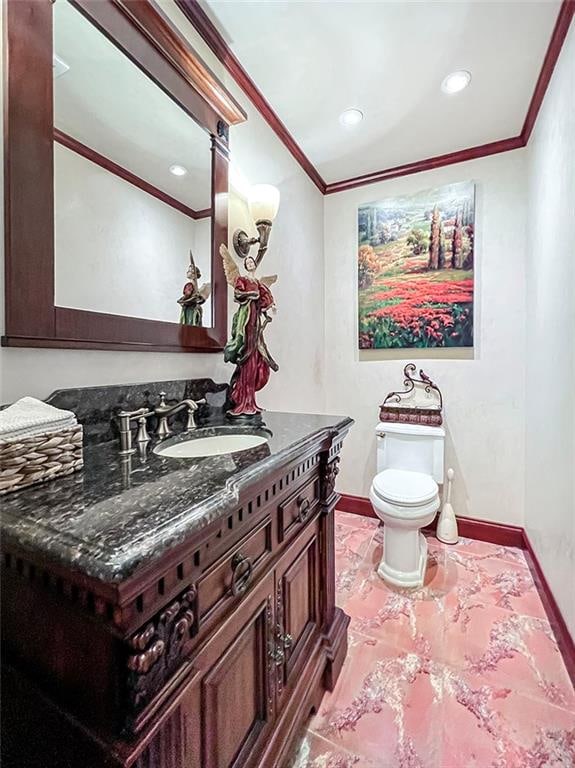 bathroom featuring vanity, baseboards, ornamental molding, recessed lighting, and toilet