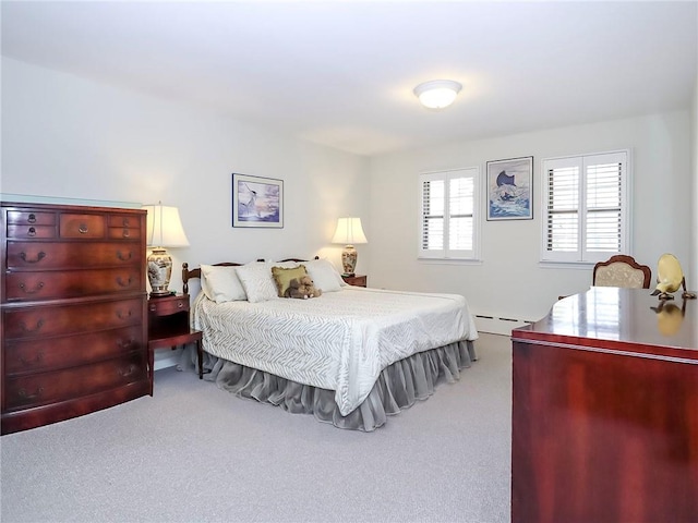 carpeted bedroom with a baseboard radiator